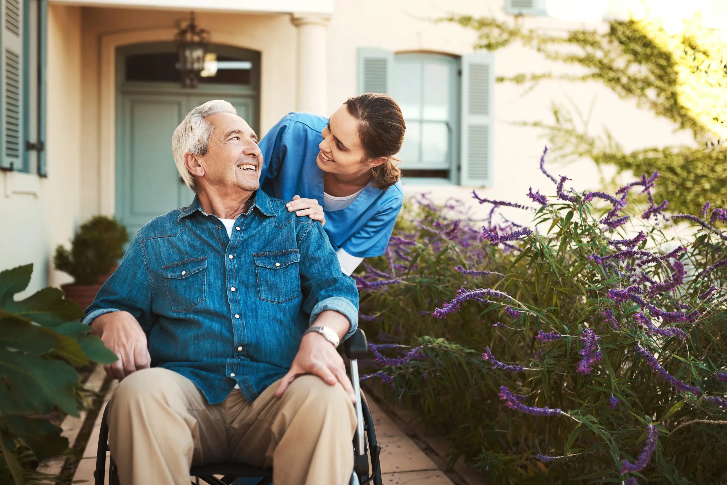 I hope you know how much youre valued. a young female nurse outside with a senior patient in a wheelchair