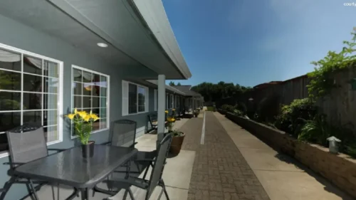 Outdoor patio area at Bridge Creek with seating and garden pathway